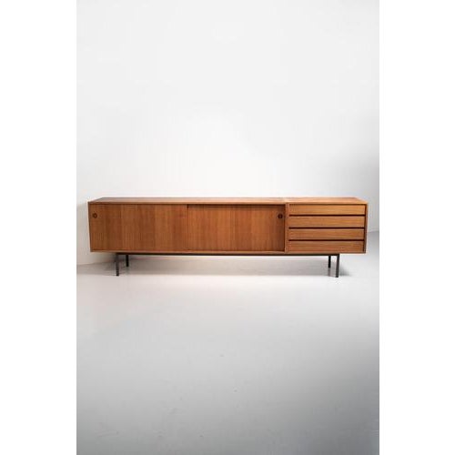 Wilhelm renz side board for walter wirz. An extra long cabinet from teak veneer and with metal legs. A sleek model with...