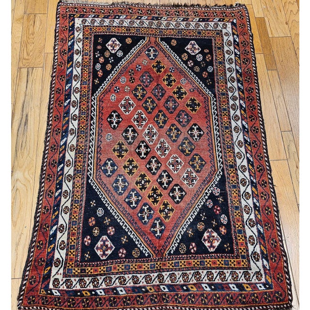 "This vintage Persian Qashqai tribal area rug, hand-knotted in Southwest Persia during the mid-20th century. The rug is...