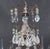 An elegant and elaborately ornamented Louis XV style sixteen-light chandelier, featuring a gracefully scrolling metal...
