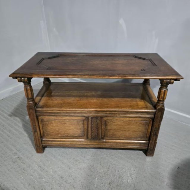 A very good medium oak hall bench, top swivells over to create a table, lift up lid for storage, excellent colour and...