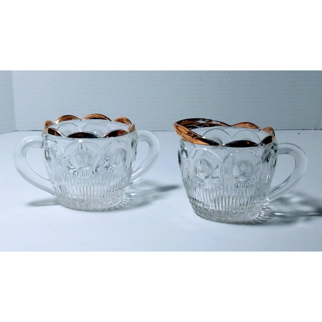 This sugar and creamer set was made in the 1950s by Bartlett Collins and called Manhattan. These are clear pressed glass...