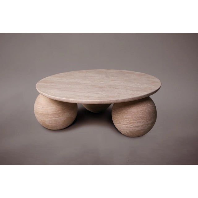 Expertly carved and hand-finished from solid blocks of vein-cut travertine, each piece exhibits the inherent variations in...