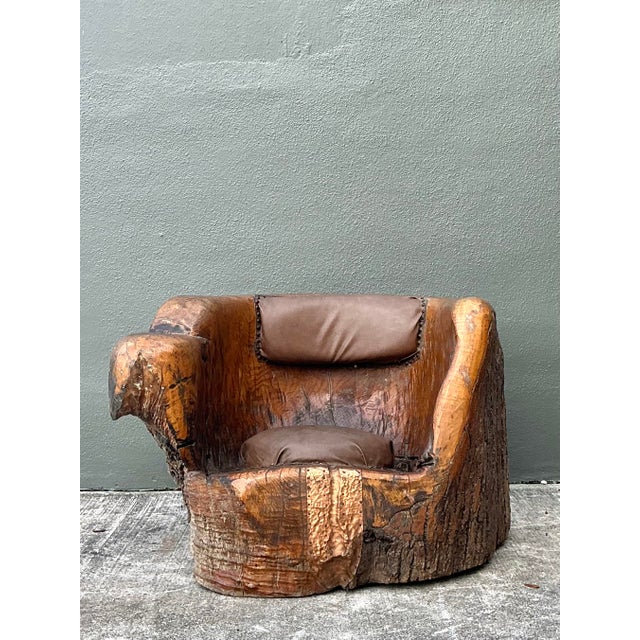 Embrace the raw beauty of the natural world with this extraordinary primitive barrel chair, expertly hand-carved from a...