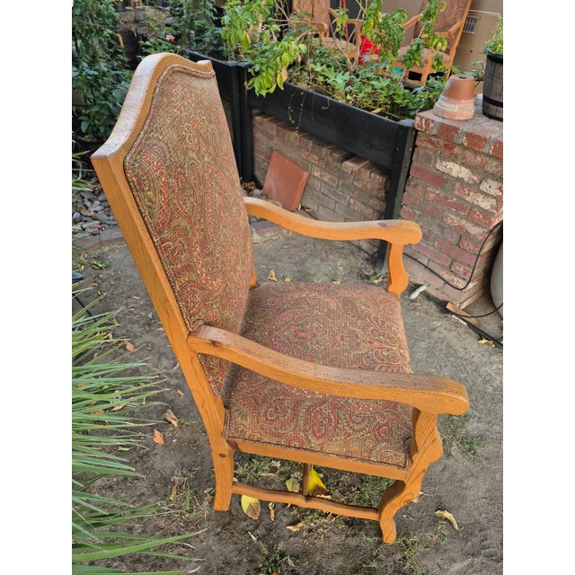 Crafted with a solid wood frame in a light honey finish, it features a grand, gently arched high-back profile and carved...