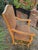 Crafted with a solid wood frame in a light honey finish, it features a grand, gently arched high-back profile and carved...