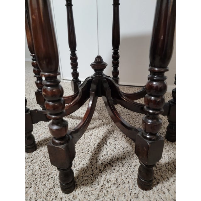 This Victorian parlor table is hand-crafted from walnut with a curved octagonal top and hand-turned legs, dating to...