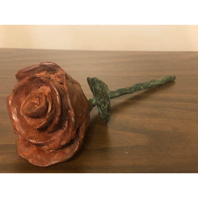 This handcrafted solid cast iron rose sculpture combines delicate natural motifs with a striking Brutalist aesthetic....