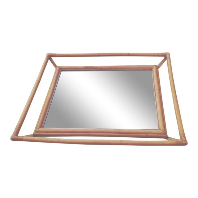 Large Mid Century era rattan wall mirror in the style of Paul Frankl/Ficks Reed that could be hung vertically or...