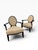 A refined pair of Baker Furniture lounge chairs showcasing a graceful barrel-back silhouette with distinctive oval...