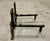 A pair of antique cast iron fireplace andirons with rust and dark oxidation, heavy oval ring finials, tapered columns,...