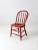 This is an antique bow back Winsdor chair. The classic red farmhouse dining chair has a turned spindle back.