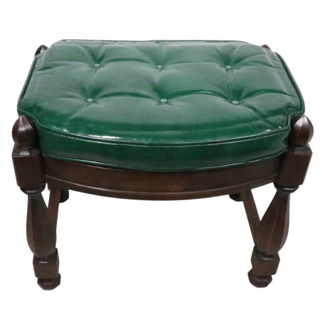 Vintage Tudor style footrest, ottoman, stool having an oak frame in original, dark finish, with a tufted green leather...