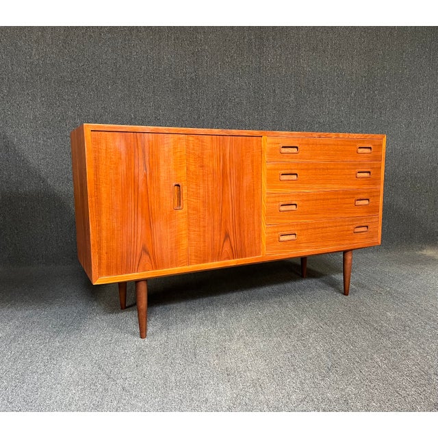 Timeless Danish modern teak credenza designed by Poul Hundevad, circa 1960s. Crafted from beautiful teak, featuring...