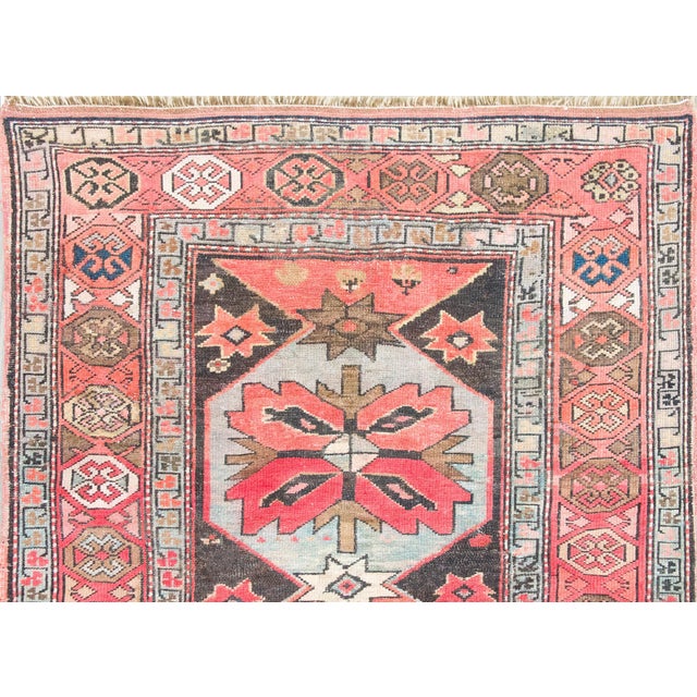 A remarkable early 20th century Persian Kazak rug with the most wonderful floral medallions running the length of the rug,...