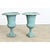 An elegant pair of late 19th century French cast iron garden urns which display a Neoclassical taste in their profile,...