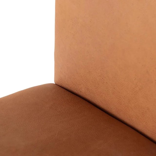 Shapely and sleek, with a scooped back and tapered legs, camel top-grain leather brings total sophistication to the dining...