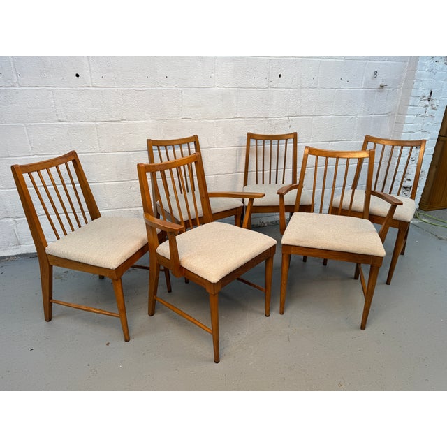 Beautiful set of six mid-century modern dining chairs featuring warm-toned solid wood frames and clean, timeless lines....