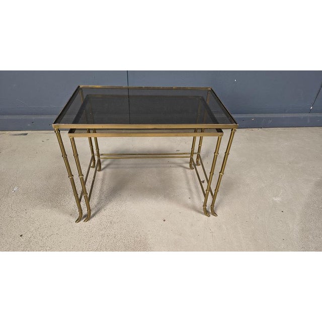 Mid century brass faux bamboo nesting tables. These elegant side tables are ideal to mix with modern day interiors to...