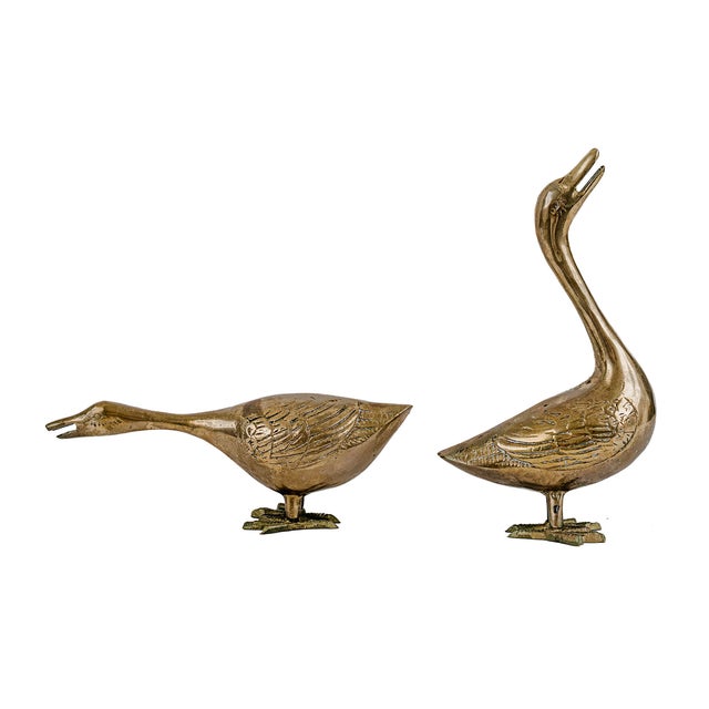 Vintage Mid-Century Modern Solid Brass Geese. Produced between the 1960s and 1970s. Featuring one goose with its neck...