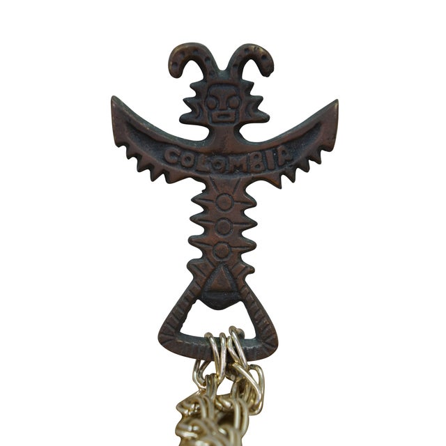 Vintage folk art garland / sleigh bells wind chime. Made from a brass totem bottle opener featuring twenty bells. Bells...