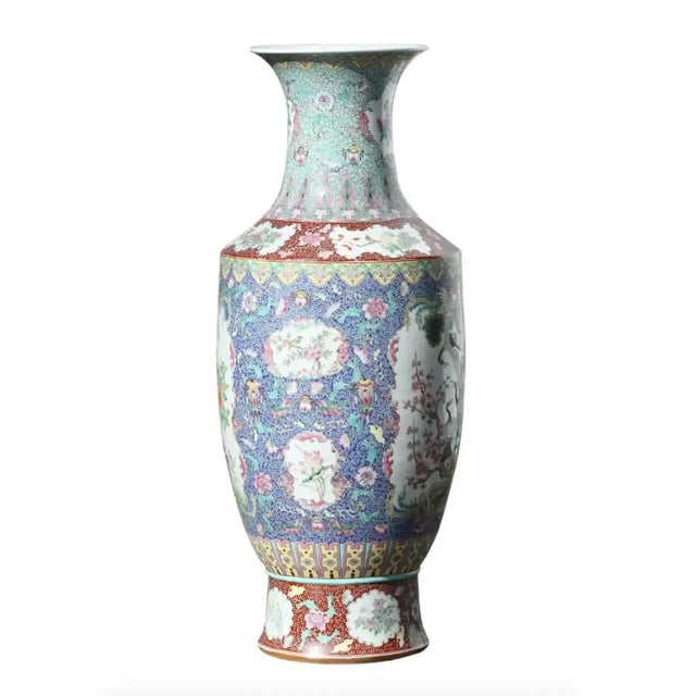 Chinese porcelain Famille Rose coral ground vase, baluster form with long neck and flared lip, painted with a stylized...