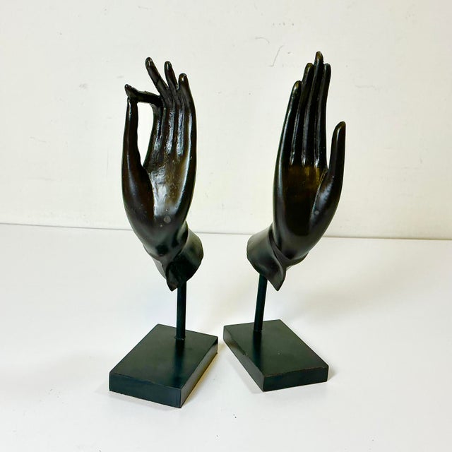 These cast metal sculptured Buddha Hands are elegant and stunning. The sculptures are presented on rectangular museum...
