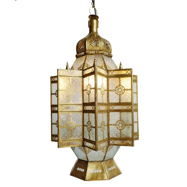 Vintage Moroccan brass and glass pendant lantern. Striking and intricate handmade piece with printed clear glass. Each may...