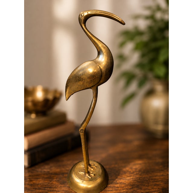 Add timeless elegance to your home with this vintage handcrafted brass crane sculpture made in India. Standing 16.75...