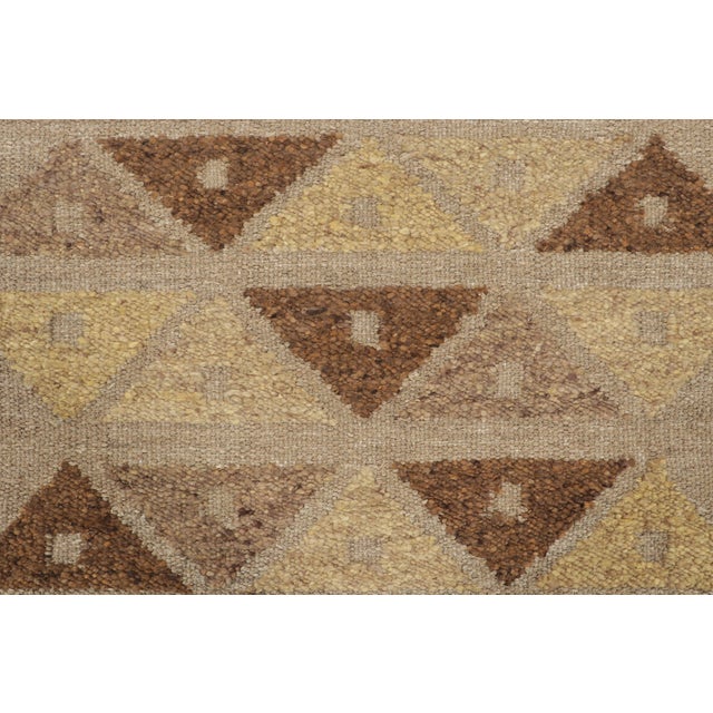 This 4x6 Scandinavian rug showcases a repeating geometric pattern in beige, brown, and golden tones. Representing the Nu...