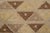 This 4x6 Scandinavian rug showcases a repeating geometric pattern in beige, brown, and golden tones. Representing the Nu...