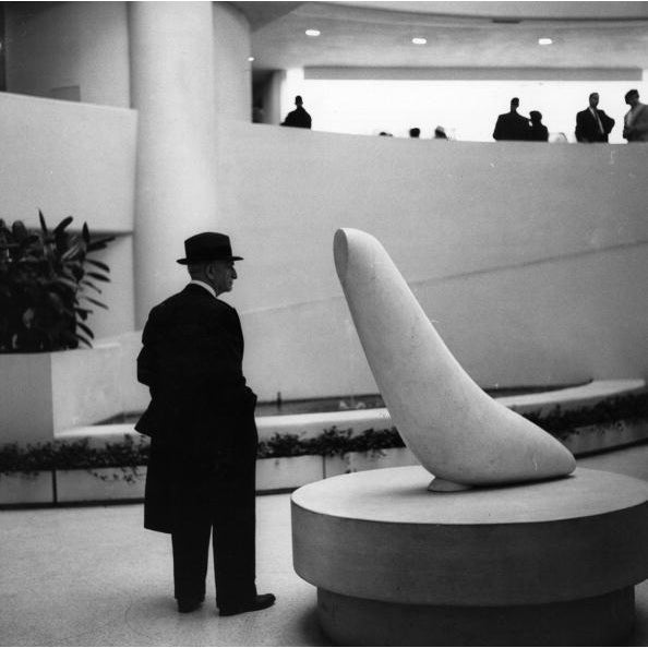 Seal Sculpture 1965: An elderly man looking at 'White Seal', a sculpture by Constantin Brancusi, at the Guggenheim Museum...