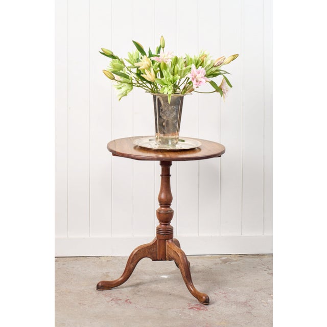 This Georgian mahogany tilt-top table features a round top made from solid mahogany and sits on a birdcage mechanism,...