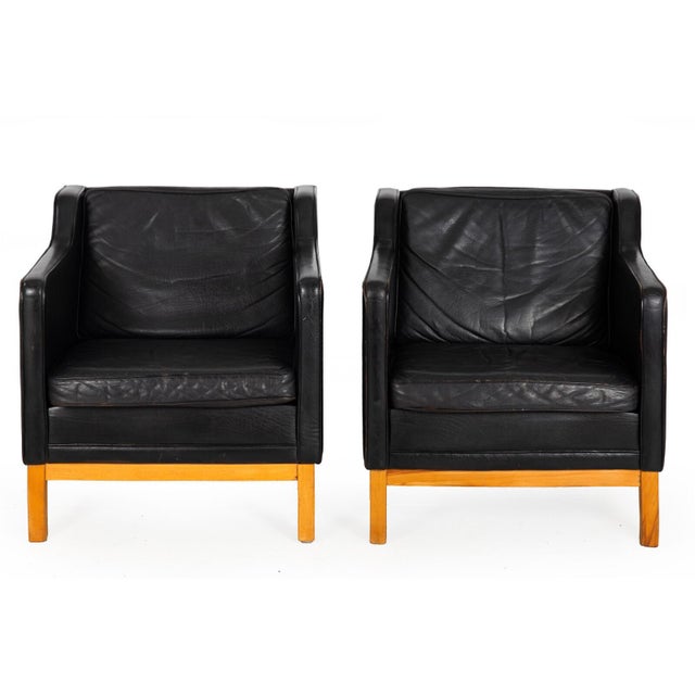PAIR OF MH195 LOWBACK ARMCHAIRS WITH OTTOMAN BY MOGENS HANSEN In top-grain black leather with blonde beechwood frames |...