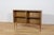This oak display cabinet was manufactured in the United Kingdom during the 1970s. The piece is raised on angled legs,...