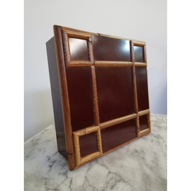 Square box from the 70's, designed and produced by Tommaso Barbi. Made in burgundy laminate with beautiful bamboo...