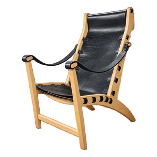 Celtia Black Leather and Solid Wood Lounge Chair For Sale