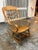 Design Plus Gallery presents a Vintage Windsor Style Arm Rocker. This handcrafted wooden rocker has a tall, contoured back...
