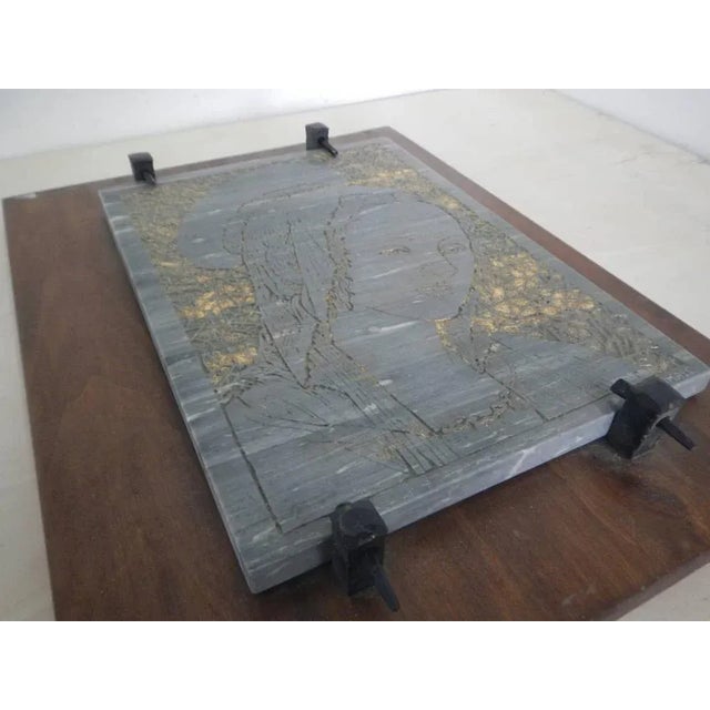 Resting on a plank of poplar wood with handcrafted iron nails supporting it Engraved and finished with golden purple. The...