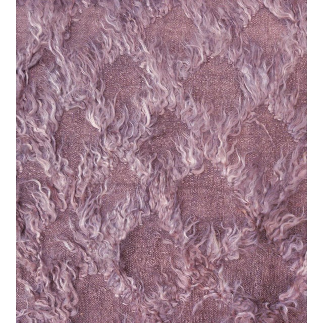 Part of the Mansour Modern collection, this handwoven rug has a mauve field with an overall mohair tufted trellis.
