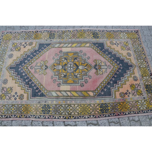 This is a vintage Turkish Oushak rug from the 1960s. The piece was hand-knotted.