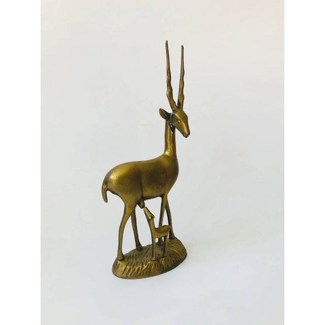 A large vintage brass gazelle with its baby. Beautiful gold patina and details formed into the brass.