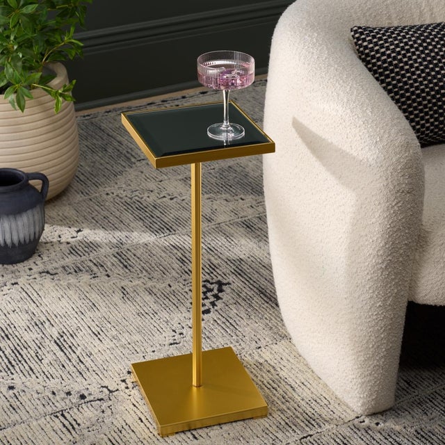 Bring elegance and sophistication into your living space with the PAKU SQUARE SIDE TABLE. Shimmering in rich gold and...