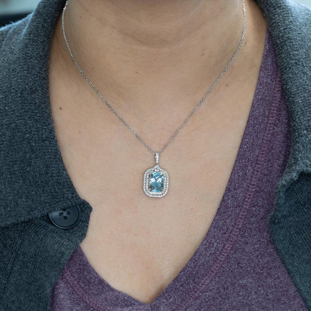 A striking 4.9ct Santa Maria aquamarine glows with rich ocean-blue depth, beautifully framed by natural diamond accents in...