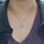 A striking 4.9ct Santa Maria aquamarine glows with rich ocean-blue depth, beautifully framed by natural diamond accents in...