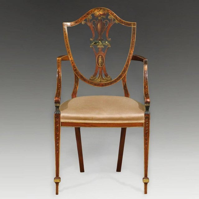 A fine English satinwood armchair dating to circa 1890 and designed in the Sheraton tradition. The elegant shield-shaped...