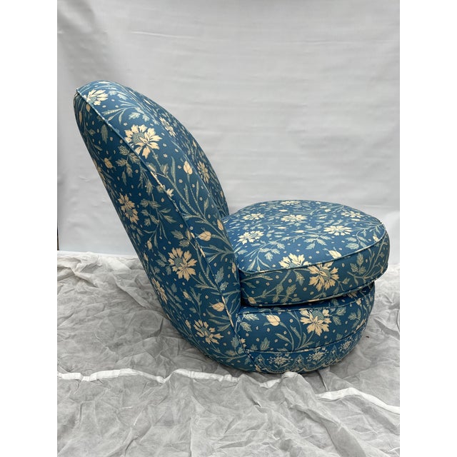 A single vintage fully upholstered low stationary slipper chair with removable two-sided box seat cushion. The lounge...