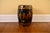 A vintage Chinese barrel-form ceramic garden stool in a black glazed finish with gold scalloped cloud motifs with raised,...