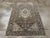 A vintage Persian Malayer accent rug. Small birds slip into the striated slate field displaying a broken, irregular...