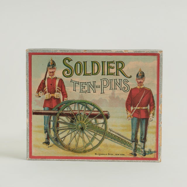 Transporting Victorian child’s game with a wood cannon, six wooden shells and eleven cardboard soldiers with printed...