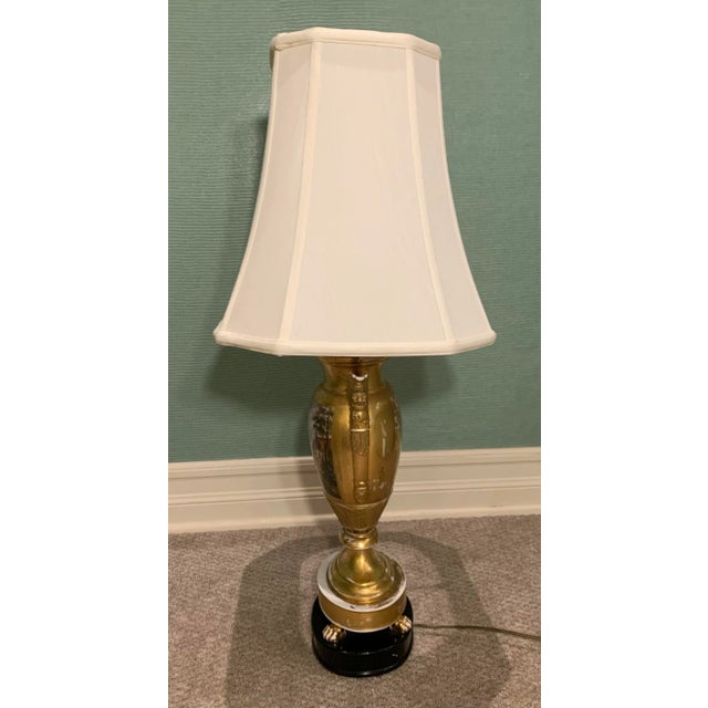 Vintage trophy ceramic lamp with painted scene of countryside pasture. Wood base and bell shade. Double medium base light...